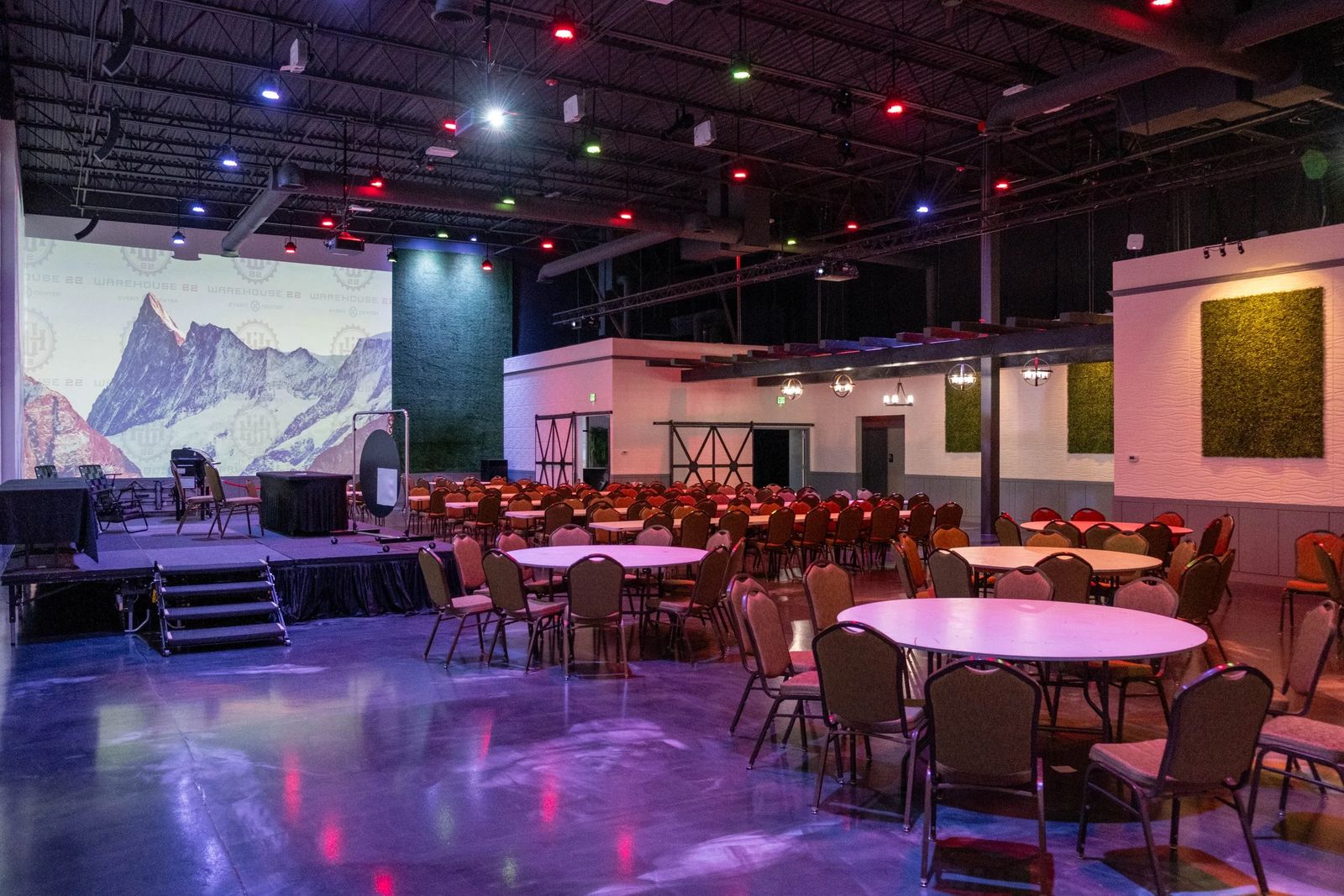Warehouse 22 hall set for a party under colored lights