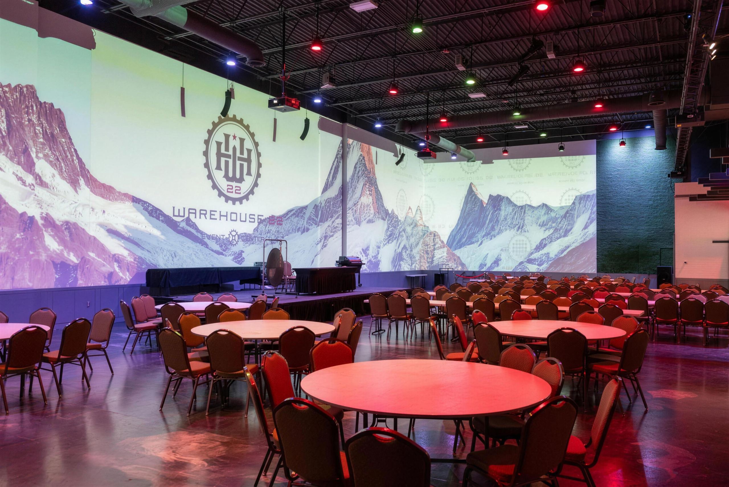 Warehouse 22 main hall with a mountain scene and stage lights